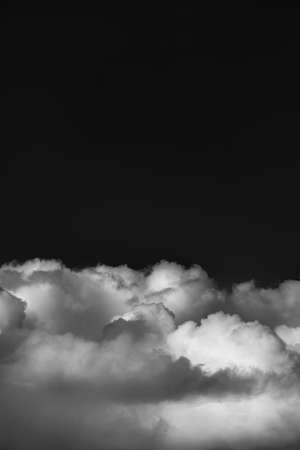 fluffy clouds on clean sky with copy space monochrome imageの写真素材