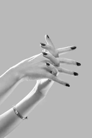 luxury female hands on white background posing close up, monochromeの写真素材