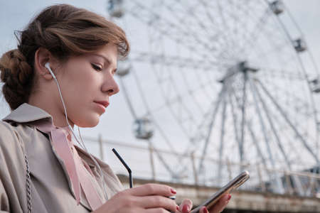 businesswoman with coffee cup looking at phone