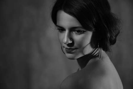 young attractive woman with bare shoulders looking aside retro style portrait, monochrome