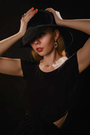 Woman Beauty in Hat, Elegant Fashion Model Retro Style Portrait on Black backgroundの写真素材