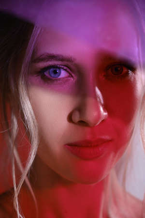 serious beautiful young woman with bare shoulders looking at camera. closeup portrait with...