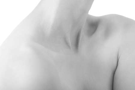 beautiful female slim neck with clavicle on black background, monochrome