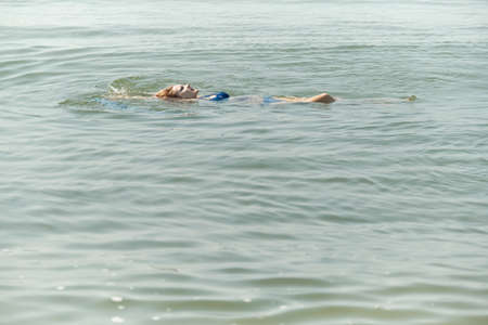 beautiful woman swim in calm tropical sea toned image