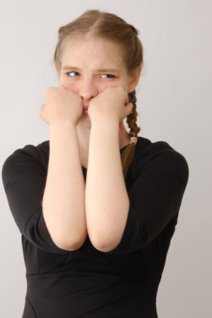 Portrait of sad or serious young woman in studio