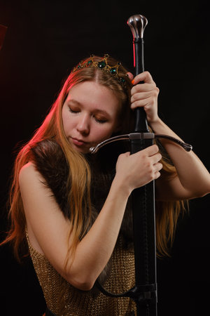 Portrait of viking woman in a traditional nordic clothes on black background