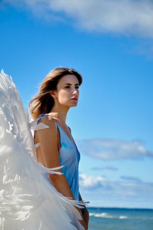 A young beautiful woman angel with white wingsの写真素材
