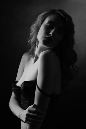 Black and white portrait of a beautiful girl in a black lingerie and bare shoulders, monochromeの写真素材