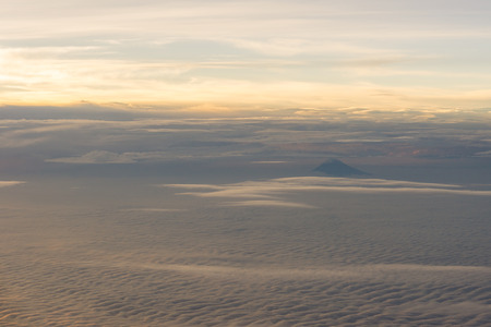 Clouds, sun, sky as seen through window of an aircraftの写真素材