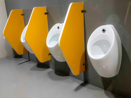 row of outdoor urinals men public toilet,Closeup white urinals in men's bathroom, design of white ceramic urinals for menの写真素材