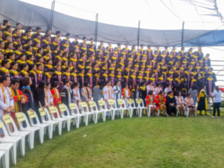 Abstract blur Crowd of student graduate class gowns standing in commencement event at universityの写真素材