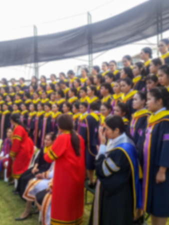 Abstract blur Crowd of student graduate class gowns standing in commencement event at universityの写真素材