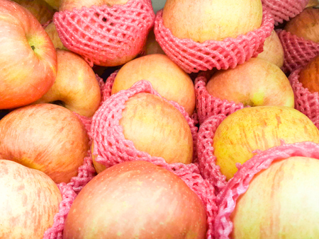 fresh red apples on a market stall for sale.の写真素材