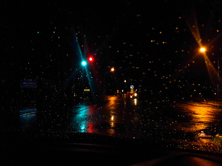 Road view through car window with rain dropsの写真素材