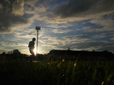 Silhouette  running on road at sunrise. Fitness and workout wellness concept.の写真素材