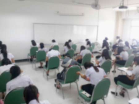 blur background of student during exams in University classroom.の写真素材