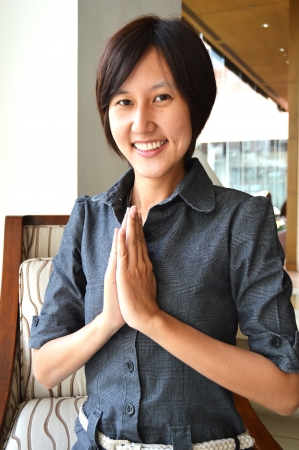 Thai women with typical welcome expression sawasdeeの写真素材