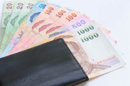 thai money banknotes and black wallet isolated on white background の写真素材