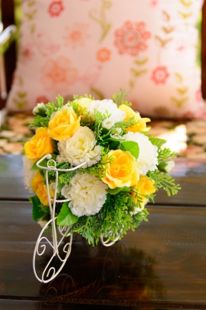 beatiful plastic bouquet of flowers on wooden table in coffee shopの写真素材