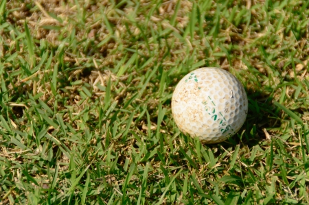 old golf ball on course with sunlightの写真素材