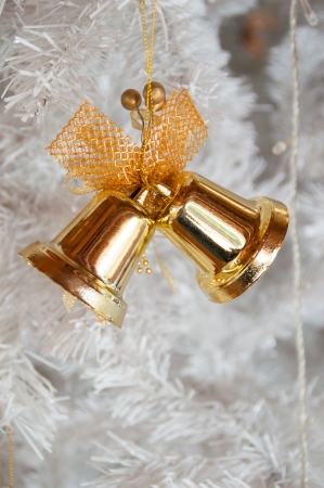 christmas bells hanging on treeの写真素材