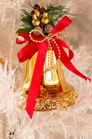 christmas bells hanging on treeの写真素材