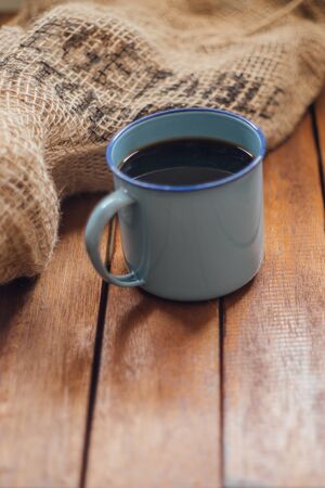 enamel mug on wood and sack bag backgroundの写真素材