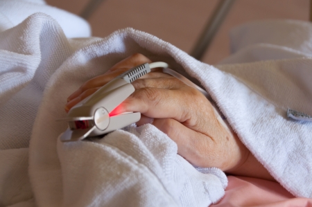 Close up of a heart monitor on a patients finger. Shallow dof, focus on monitor only.の写真素材