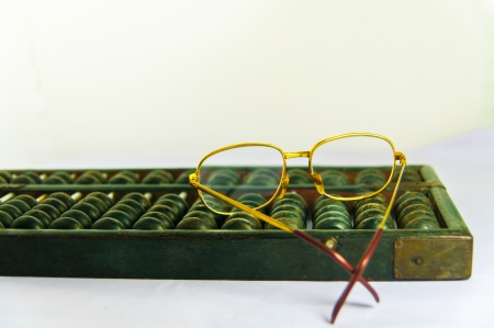 close up of Old Chinese Abacus and glassesの写真素材