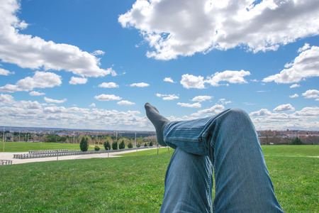 Men's feet in socks on relaxation in park with blue skyeの写真素材