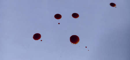 Red water droplets on a white background