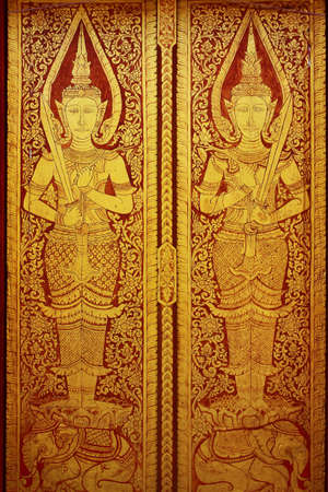 Traditional Thai style painting art on the temple doorの写真素材