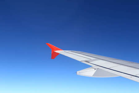 Looking through window airplane during flight in wing with a nice blue sky の写真素材