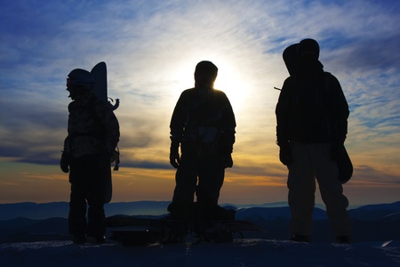 Silhouettes of the three backcountry freeriders in evening (Dragobrat ski resort, Ukraine).のeditorial素材