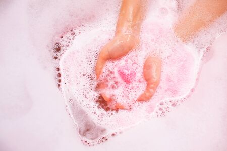 Bath salt ball dissolves in the hands.の写真素材