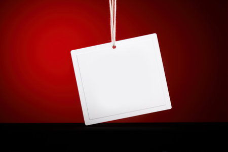 Blank white price tag hanging on a red background. 3d renderingの素材