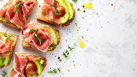 Sandwiches with prosciutto, avocado, tomatoes and herbs on a light background.の素材