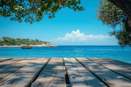 Wooden table top on the beach with blue sea and sky backgroundの素材