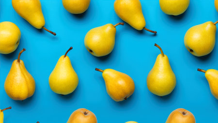 Ripe yellow pears on blue background. Top view, flat layの素材