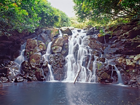 A pleasant little waterfall in deep forest in summer dayの写真素材