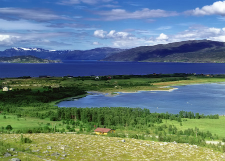 Panoramic view to river with farmland and mountains, Norwayの写真素材