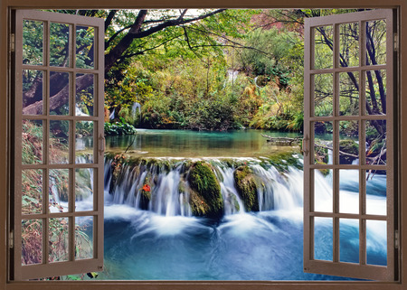 Open window view to small waterfall on the riverの写真素材