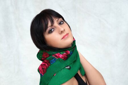 Portrait of a young beautiful woman, smooth healthy skin with minimal makeup, naturalness and beauty. Charming brunette on a gray background.の写真素材