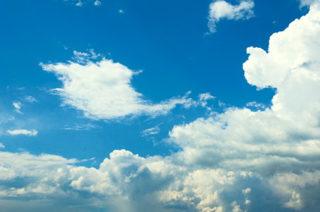 White cumulus clouds on a blue sky. summer day. before the rain.の写真素材