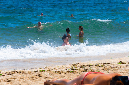 People sunbathe and swim in the sea. Black Sea, Crimea, 2019.08.16.の写真素材