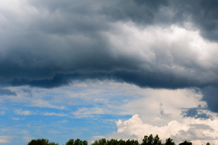 Gray white clouds. Clouds of thunderclouds on a blue sky. Summer day.の写真素材