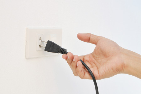 Hand unplug , electric shockの写真素材