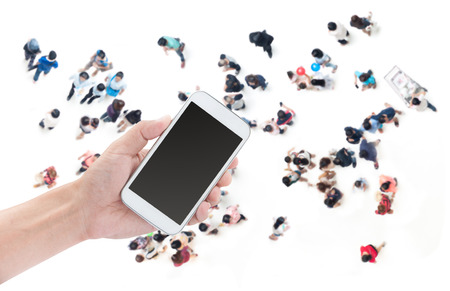 Hand holding smart phone on people shopping backgroundの写真素材