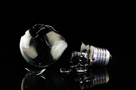 Lightbulb is broken on black background