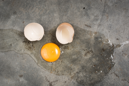 Egg fall and broken on concrete floorの写真素材